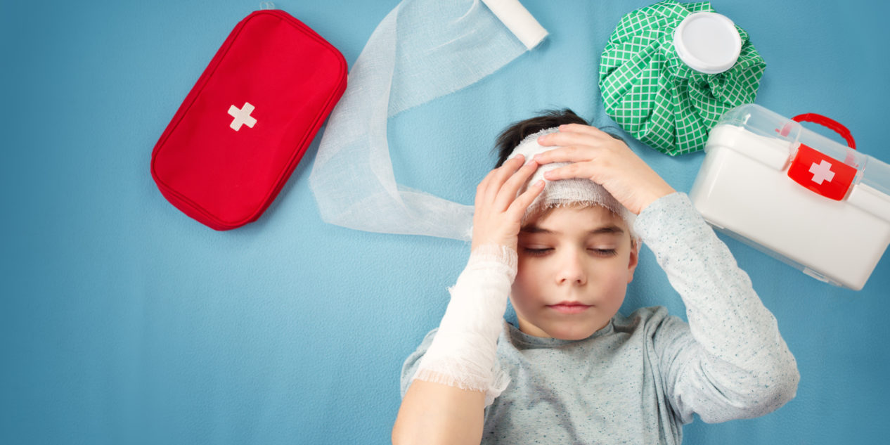 Child with bandages lying in bed